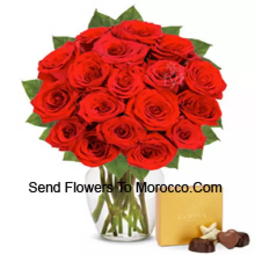 25 Red Roses With Some Ferns In A Glass Vase Accompanied With An Imported Box Of Chocolates