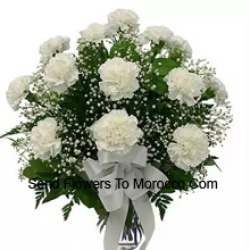 19 White Carnations With Seasonal Fillers In A Glass Vase