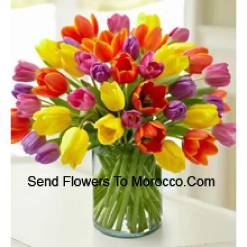 Mixed Colored Tulips In A Glass Vase - Please Note That In Case Of Non-Availability Of Certain Seasonal Flowers The Same Will Be Substituted With Other Flowers Of Same Value