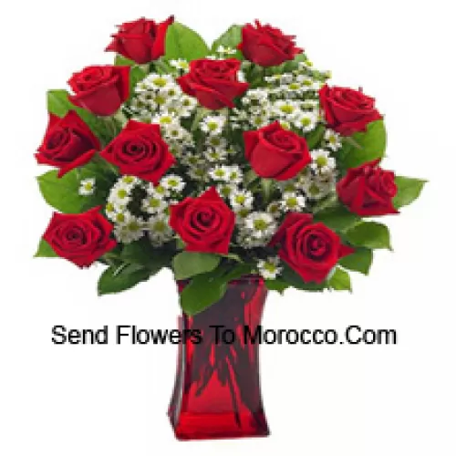 11 Red Roses With Some Ferns In A Glass Vase