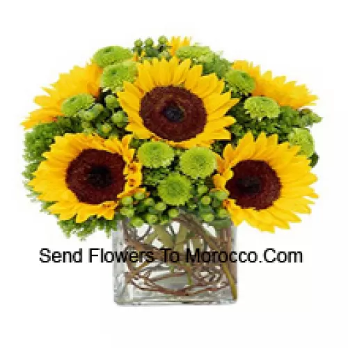 Sunflowers With Suitable Seasonal Fillers Arranged Beautifully In A Glass Vase