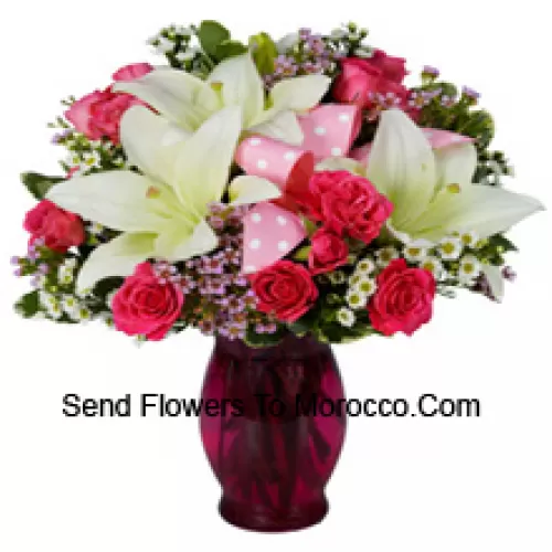 Pink Roses And White Lilies With Seasonal Fillers In A Glass Vase