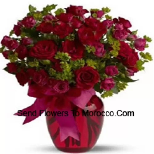 26 Red And 25 Pink Roses With Some Ferns In A Glass Vase