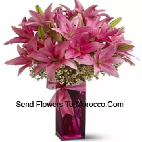 Beautiful Pink Lilies With Some Ferns In A Glass Vase