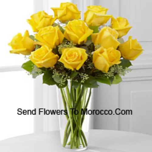 11 Yellow Roses With Some Ferns In A Glass Vase