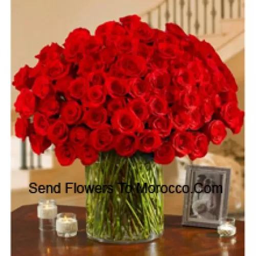 101 Red Roses With Some Ferns In A Big Glass Vase