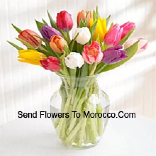 Mixed Colored Tulips In A Glass Vase - Please Note That In Case Of Non-Availability Of Certain Seasonal Flowers The Same Will Be Substituted With Other Flowers Of Same Value