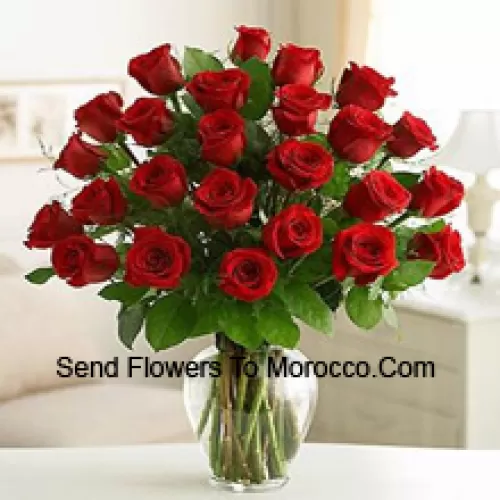 25 Red Roses With Some Ferns In A Glass Vase