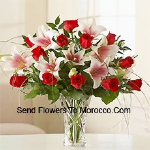 Red Roses And Pink Lilies With Seasonal Fillers In A Glass Vase