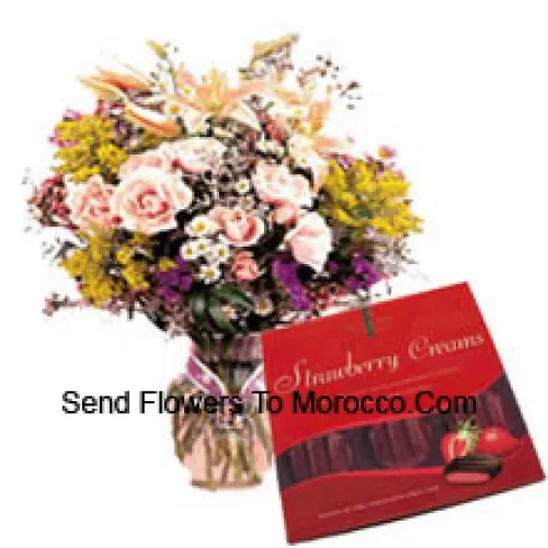 Assorted Flowers In A Vase And A Box Of Chocolate