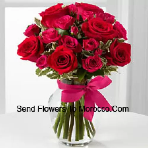 19 Red Roses With Seasonal Fillers In A Glass Vase Decorated With A Pink Bow