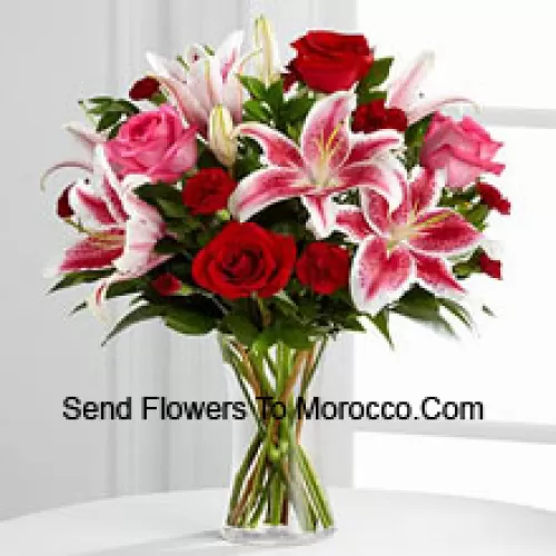 Red And Pink Roses With Pink Lilies And Seasonal Fillers In A Glass Vase