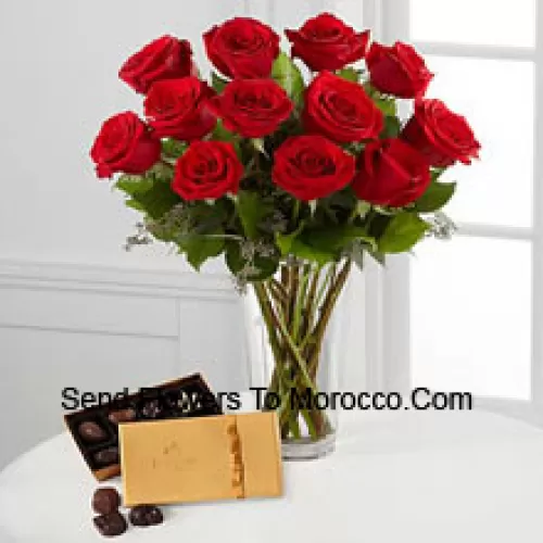 11 Red Roses With Some Ferns In A Vase And A Box Of Godiva Chocolates (We reserve the right to substitute the Godiva chocolates with chocolates of equal value in case of non-availability of the same. Limited Stock)