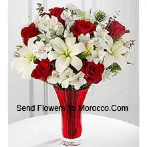 This Bouquet is a gorgeous expression of yuletide joy and elegance. Red roses pop against a background of white Asiatic lilies and Peruvian lilies lovingly arranged in a red designer glass vase to create a bouquet of seasonal celebration. (Please Note That We Reserve The Right To Substitute Any Product With A Suitable Product Of Equal Value In Case Of Non-Availability Of A Certain Product)