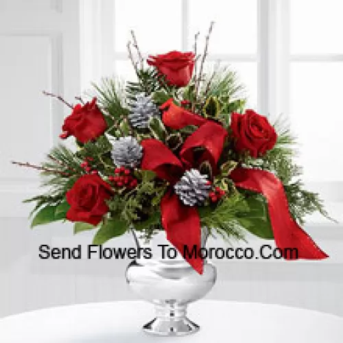 Highly elegant and bursting with your merriest wishes, this bouquet will create the perfect holiday gift. Rich red roses are vibrant and bright arranged with variegated holly, assorted holiday greens, silver pinecones and branches, all perfectly accented with a faux cardinal and designer red ribbon. Presented in a silver pedestal vase, this bouquet will add to the joy and festivities of their holiday season with each gorgeous bloom. (Please Note That We Reserve The Right To Substitute Any Product With A Suitable Product Of Equal Value In Case Of Non-Availability Of A Certain Product)