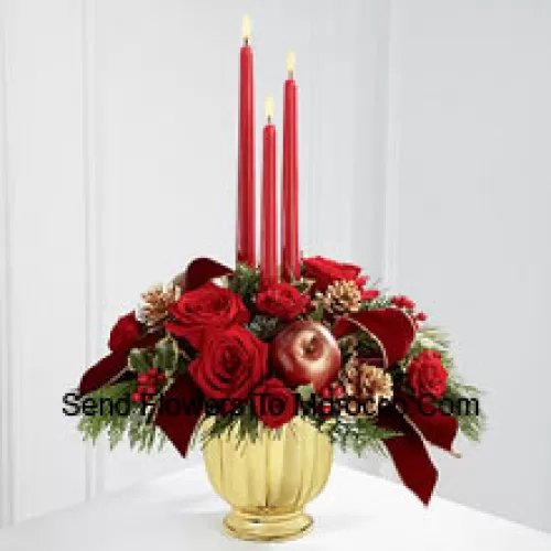 The grandeur and rich beauty of the Christmas season are highlighted with each crimson bloom. Bright red roses and spray roses are arranged in a designer gold container amongst variegated holly and assorted holiday greens. Accented with artificial apples, gold pinecones and gold-edged burgundy ribbon, this gorgeous centerpiece displays three red taper candles to create the perfect atmosphere for their holiday celebration.  (Please Note That We Reserve The Right To Substitute Any Product With A Suitable Product Of Equal Value In Case Of Non-Availability Of A Certain Product)